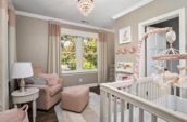 baby room with couch, bedside table and crib